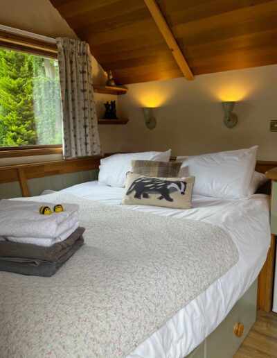 Comfortable king sized bed with Hypnos mattress within Badger cabin