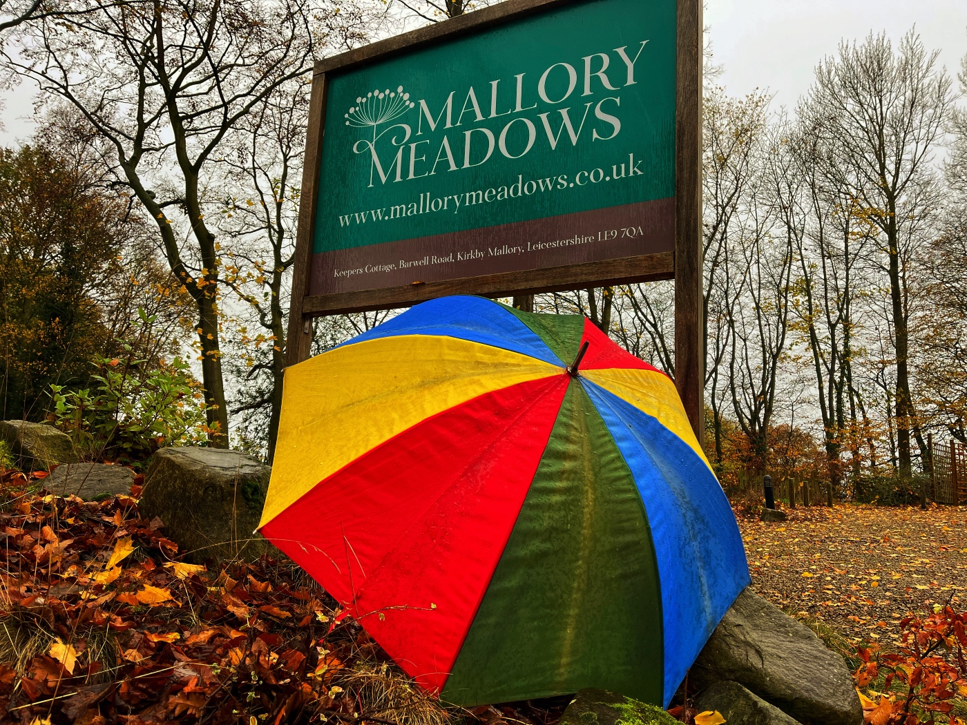 Welcome to Malory Meadows sign with colourful umbrella. Rainy Day ideas